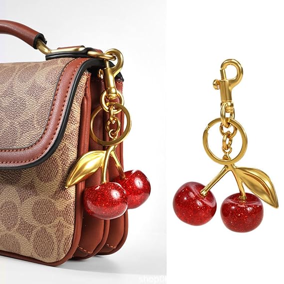 Red glitter cherry keychain by SALVE featuring a shiny, sparkly cherry charm with a silver keyring attachment.