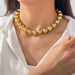 Salve chunky gold beaded aesthetic necklace featuring large gold beads on a stylish chain for a trendy jewelry look