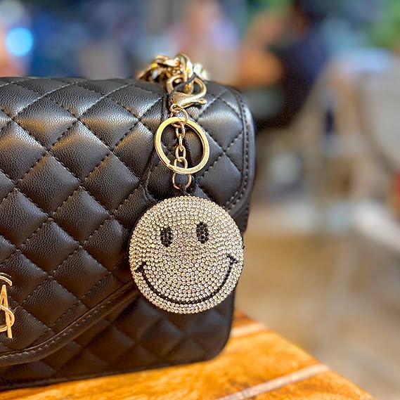 Yellow Puffy Smiley Face Keychain by SALVE with a cheerful smile, soft texture, and attached metal keyring.