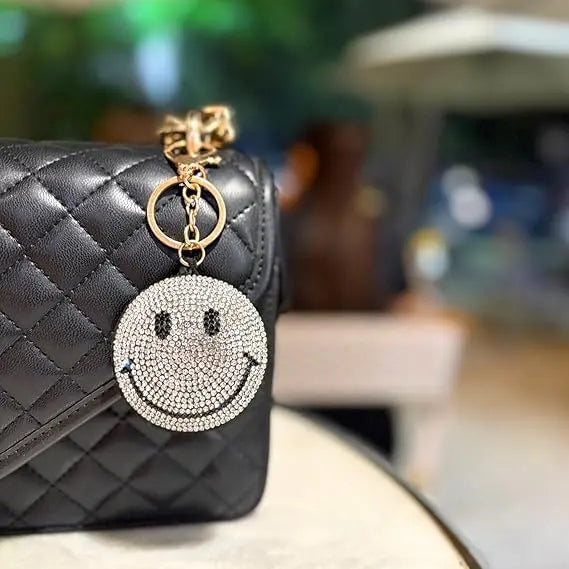 Salve Puffy Smiley Face Keychain with yellow plush fabric and metal keyring, featuring a cheerful, rounded smiley face design.