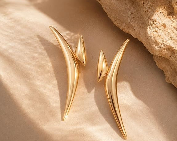 SALVE chic abstract statement earrings featuring bold, artistic design with geometric shapes in metallic finish.