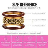 Stack of chunky wooden bangle bracelets by SALVE, featuring natural wood textures and varying sizes for a stylish accessory.