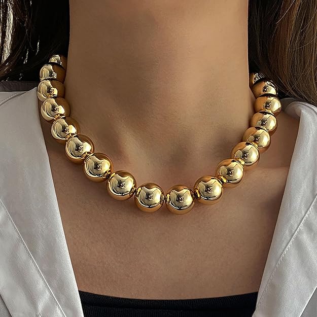 Salve chunky gold beaded aesthetic necklace with large round beads, stylish jewelry accessory on a neutral background.